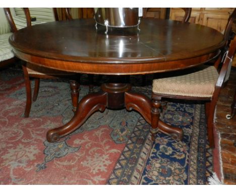 A Victorian mahogany dining suite, the table of circular form raised on tripod base, together with six upholstered chairs.