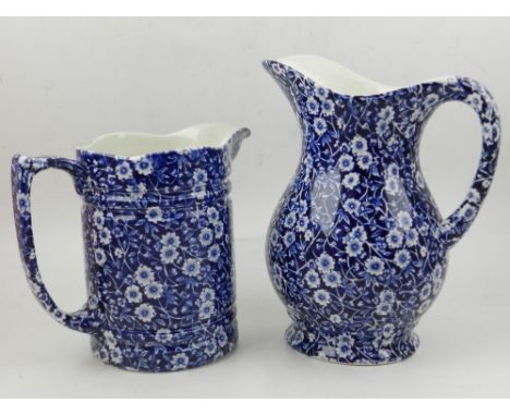 Two calico Burleigh pottery jugs, decorated with scrolling foliage, bears factory mark to base. H.22cm (tallest)