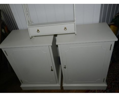 A pair of white painted bedside cupboards, together with a wall hanging shelf. 