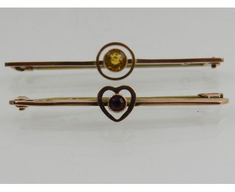 A 9 carat yellow gold bar brooch set with a citrine, together with a 9 carat bar brooch set with a small ruby. (2)