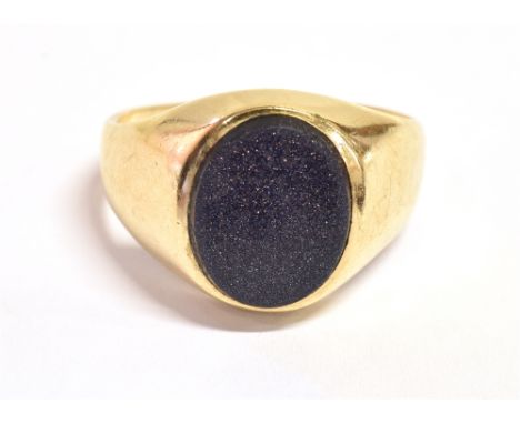 A 9CT GOLD BLUE GOLDSTONE SIGNET RING The oval goldstone measuring 1.2cm X 1cm on a tapered yellow gold shank with rubbed hal