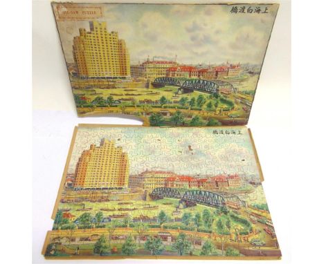 TWO WOODEN JIGSAWS OF CHINESE INTEREST  the first with a colour printed view of the Garden Bridge, Shanghai, complete (seven 