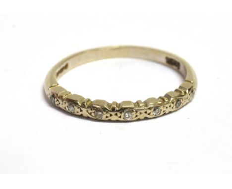 A STAMPED 750 WHITE GOLD AND DIAMOND ACCENTED HALF ETERNITY RING Ring size approx. K, weight 1.8g Condition Report : Shank in