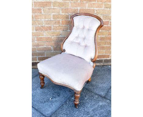 A VICTORIAN BUTTON UPHOLSTERED MAHOGANY FRAMED NURSING CHAIR  with serpentine front seat, on turned supports Condition Report