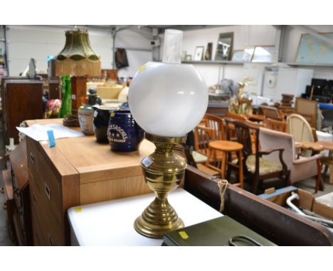 A brass oil lamp with shade