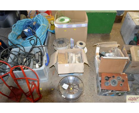 A quantity of electrical fittings and cable; a box of levelling tools and a reel of wire