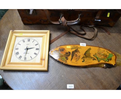 A pine wall clock and wooden plaque decorated with bats