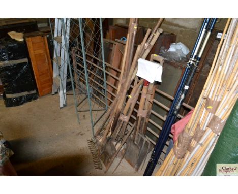 A collection of long handled garden tools to include rakes, shovel, spades, forks etc.