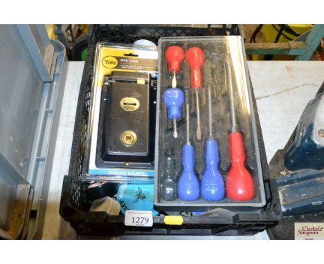 A box containing a part screw driver set; a Yale ring lock; tapes measures various tools etc. 