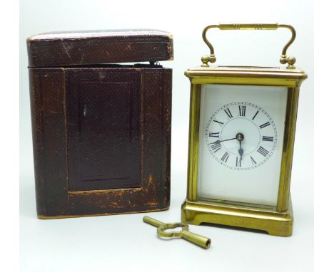A French gilt brass and four glass sided carriage clock in leather travel case 