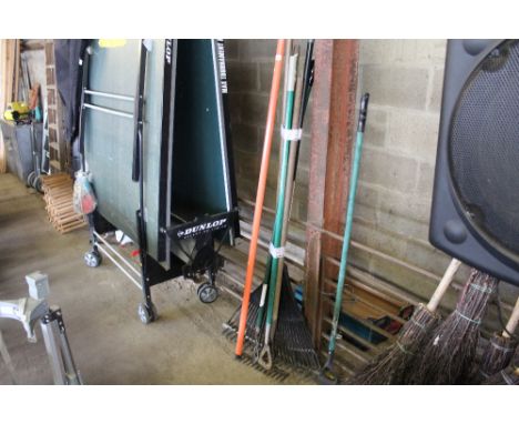 A quantity of long handled gardening tools to include hoes, rakes etc