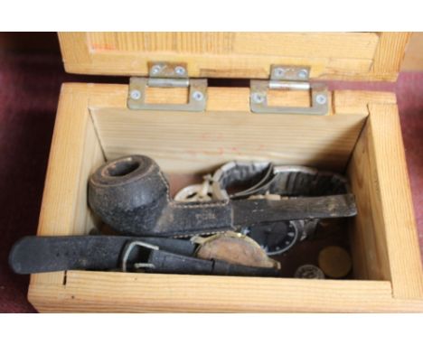A trinket box containing various wrist watches, sporting medals, leather mounted pipe etc.