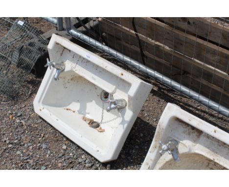 A vintage basin with cold and hot taps
