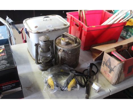An enamel bread bin, hanging oil lantern, metal can, ear protectors and a soldering iron