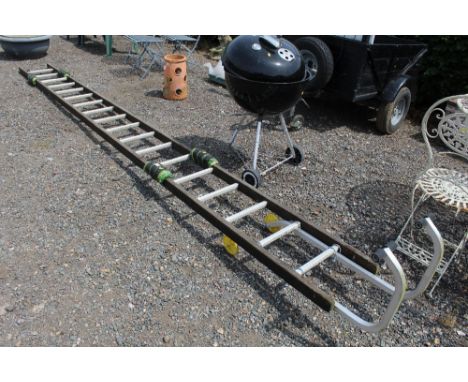 A large wooden ladder with metal ridging hooks