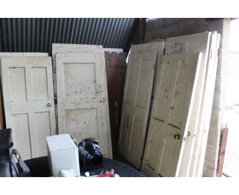A large quantity of white painted internal doors of varying sizes and a garden gate