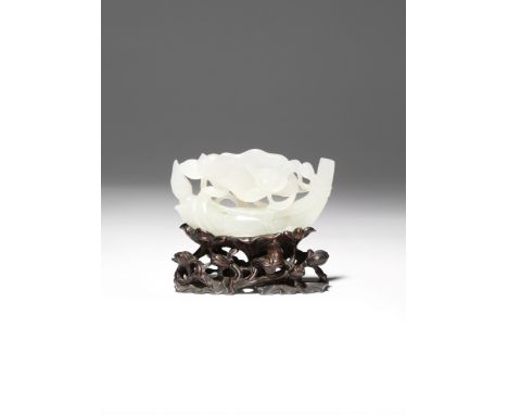 A CHINESE WHITE JADE 'LOTUS' CARVING 18TH CENTURY Carved in openwork as two lotus blooms and large furling leaves growing aro