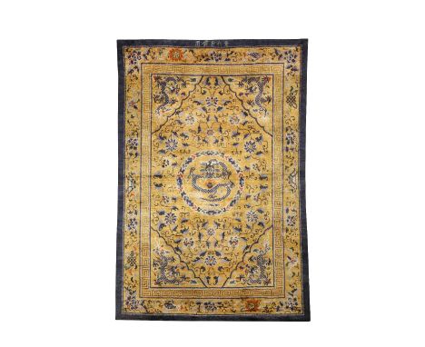 A RARE CHINESE IMPERIAL GOLD-GROUND SILK 'FIVE DRAGON' RUG LATE QING DYNASTY Decorated with a central medallion enclosing a b