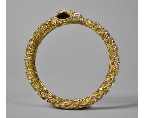 A Heavy Gilt Metal Bangle in the Form of a Snake 