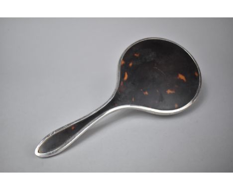 A Silver and a Tortoiseshell Dressing Table Mirror 