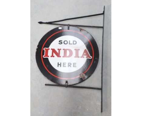 A Black and Red Circular Enamel Double-Sided Advertising Sign: India Sold Here, mounted on a metal wall bracket, the sign 61c