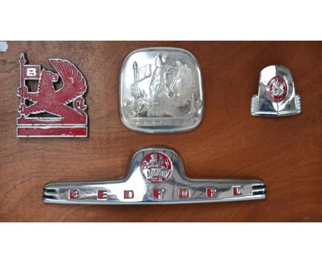Four Chromed and Enamel Bedford Motor Vehicle Badges, mounted on a wooden board  Buyer's premium of 20% (+VAT) applies to thi