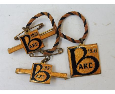 A set of three Brooklands Automobile Racing Club enamel members badges for 1931, stamped to reverse no. 487.