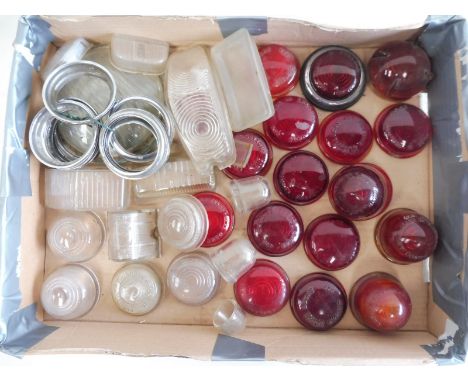A tray of mostly glass tail lamp lenses, rims etc. 