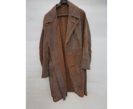A full length leather coat, heavily lined so possibly a pilot's flying coat plus a fur lined flying helmet.