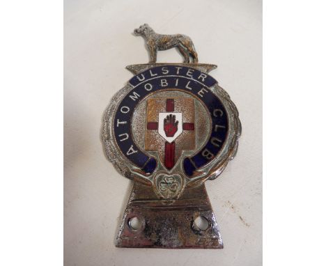 An Ulster Automobile Club part enamel badge surmounted by a standing hound, by Fray.