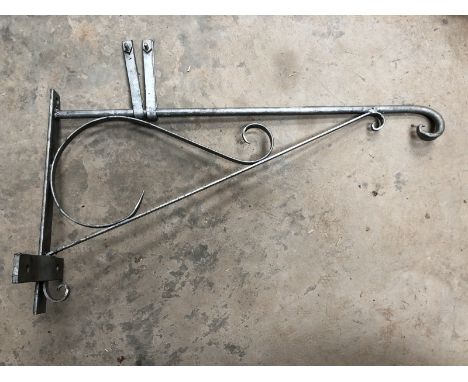 A metal hanging bracket for a lightbox or enamel sign.