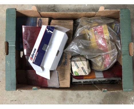 A box of assorted lamp lenses, Ford new old stock etc.