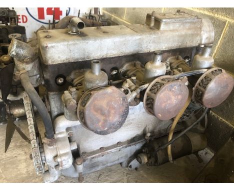 An AC 2-litre 6-cylinder engine, with triple carburettors, starter, dynamo and exhaust manifold.