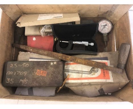 A box of tools including several for measuring. 