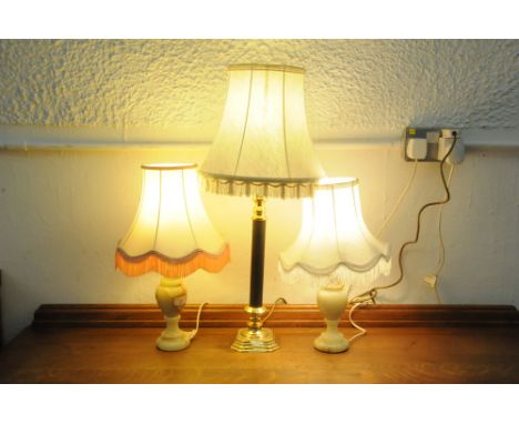 A pair of matching table lamps and shades and a single table lamp and shade  