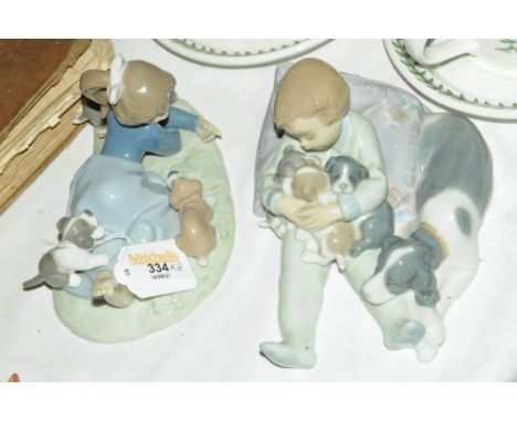 Two Lladro figures of children playing with dogs