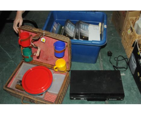 Picnic hamper and box of books and a video player 