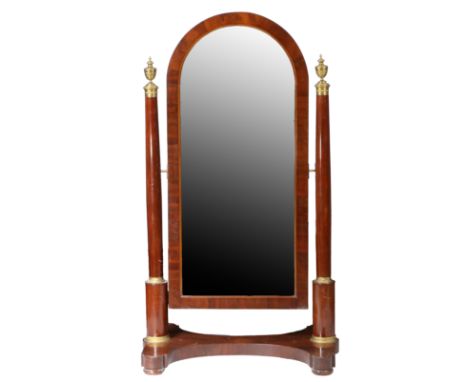 an arched mirror set in a conforming frame and able to swing and adjust, flanked by a pair of columns with urn finials, shape