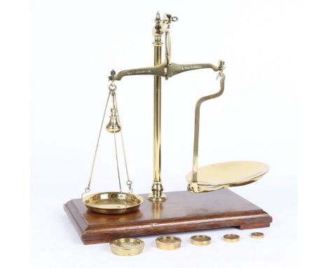 The set of brass on mahogany shop scales marked 'W. &amp; T. AVERY LTD.', together with a set of Avery brass weights. Approx.