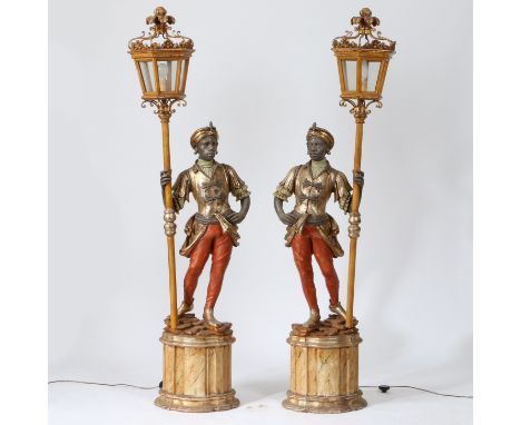 resin figures mounted on plinth bases holding a lantern, 202cm high (2).