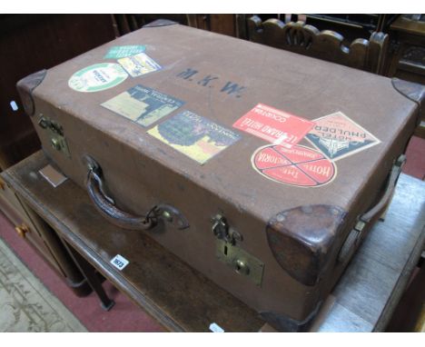 An Early XX Century Canvas and Leather Trunk/Case, brass locks and some travel labels.
