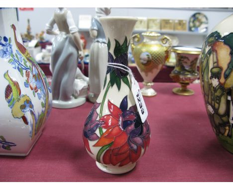 A Moorcroft Pottery Vase, painted with the Ruby Red pattern designed by Emma Bossons, impressed and painted marks, 16cm high.