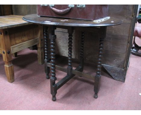 Oak Folding Table, circa 1920's, with oval top, on bobbin supports.