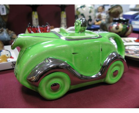 A c.1930's Art Deco Green Pottery Racing Car and Driver Teapot, with registration plate OK T42.