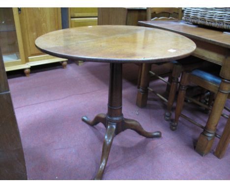 An XVIII Century Oak Pedestal Table, with snap action to circular top, turned tapering pedestal, tripod legs, pad feet.