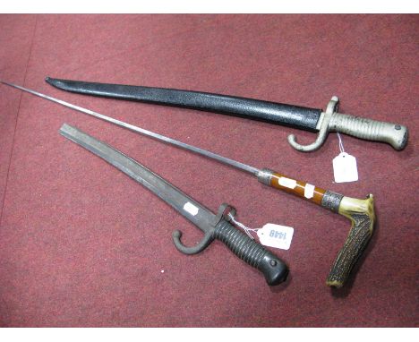 A Horn Handled Sword Stick, with silver ferrule but no sheath, bayonet with painted sheath, another with damaged blade. (3)