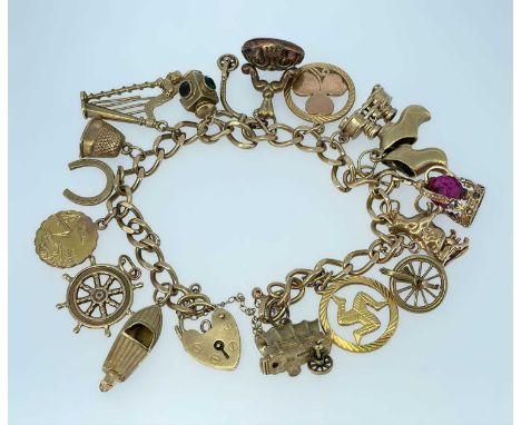 9CT GOLD CHARM BRACELET having 9ct gold heart padlock, sixteen 9ct gold charms including harp, speed boat, clogs, cow ETC, to