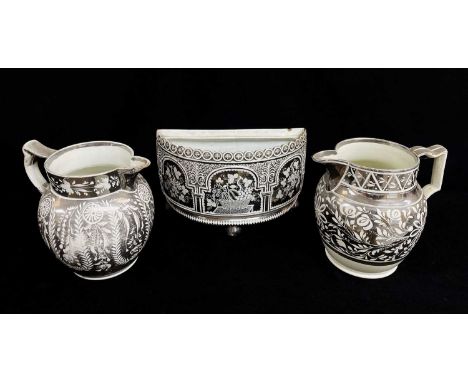 THREE BELIEVED SWANSEA EARTHENWARE SILVER LUSTRE ITEMS comprising half-moon bulb pot of architectural form on three bun-feet,