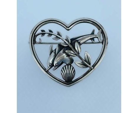 GEORG JENSEN SILVER BROOCH, modelled as a pair of dolphins within a heart shaped border, No 312, designed by Arno Malinowski,