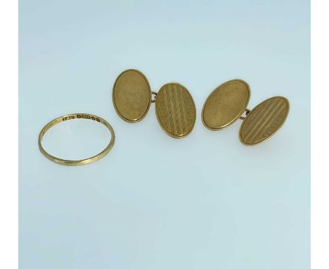 9CT GOLD JEWELLERY comprising pair of 9ct gold engine turned oval cufflinks and a 9ct gold band, 5.7gmsProvenance: private co